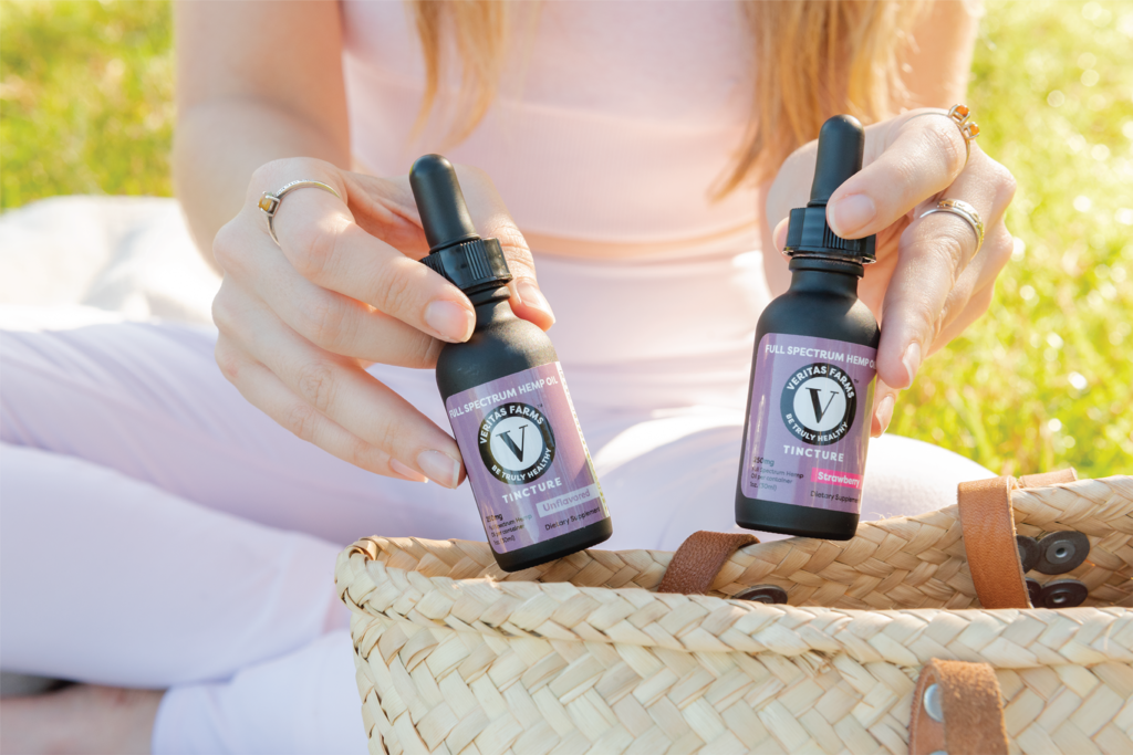 Woman Holding Full Spectrum CBD Tinctures | Veritas Farms