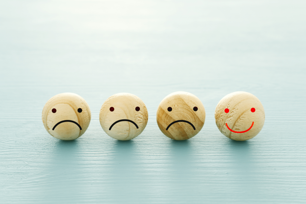 Faces Painted on Wooden Buttons Representing Different Moods | Veritas Farms