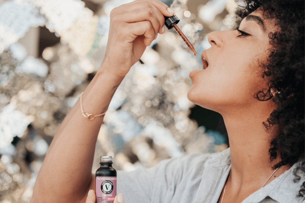 Woman Using VEritas Farms CBD Tincture | Veritas Farms