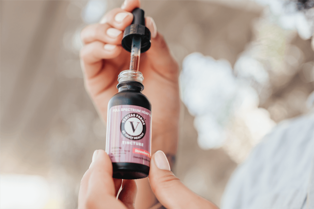 Person Using Veritas Farms Tincture | Veritas Farms