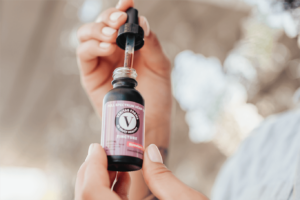 Person Using Veritas Farms Tincture | Veritas Farms
