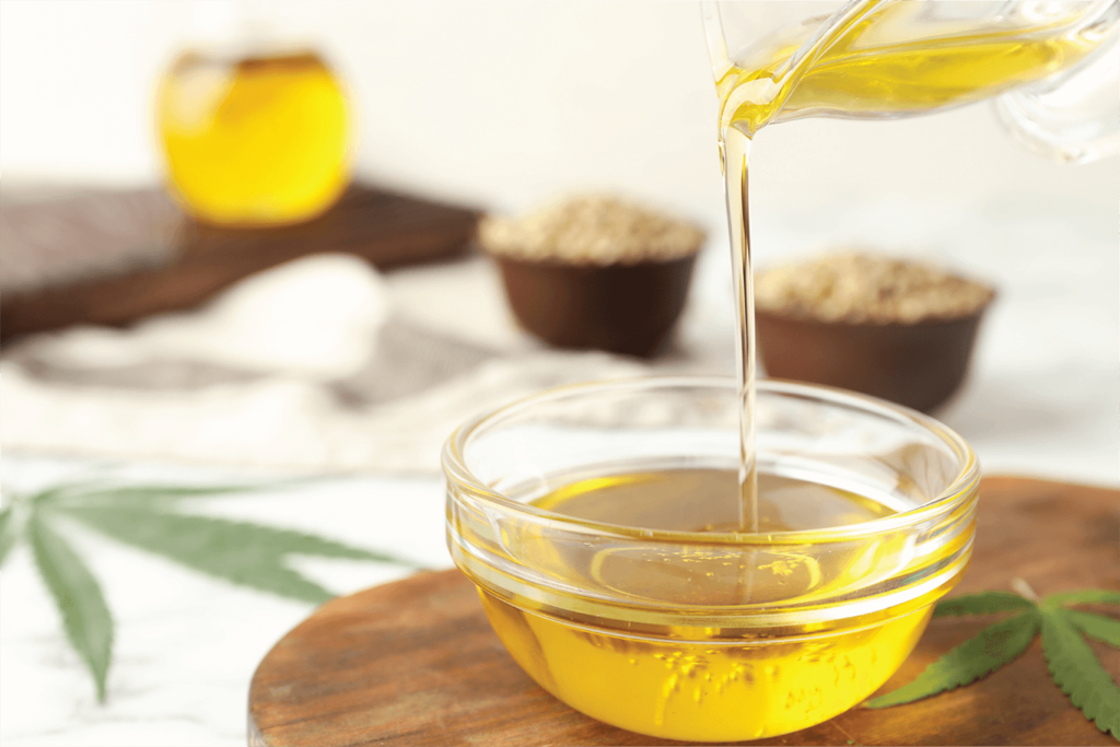 Hemp Oil Being Poured in a Glass Container | Veritas Farms