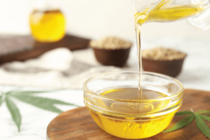 Hemp Oil Being Poured in a Glass Container | Veritas Farms